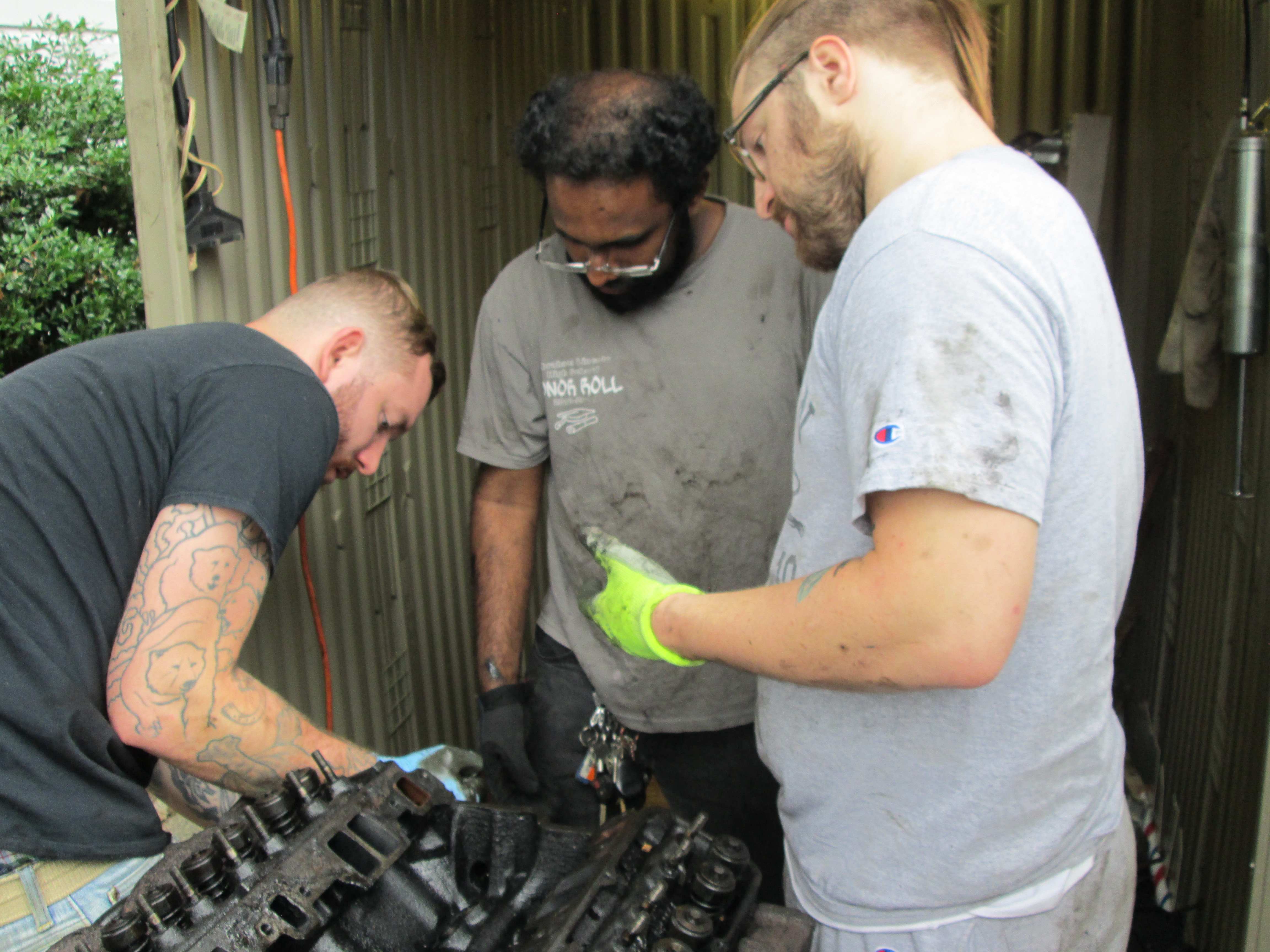 Brandon, Stephen, and Nick work on the engine